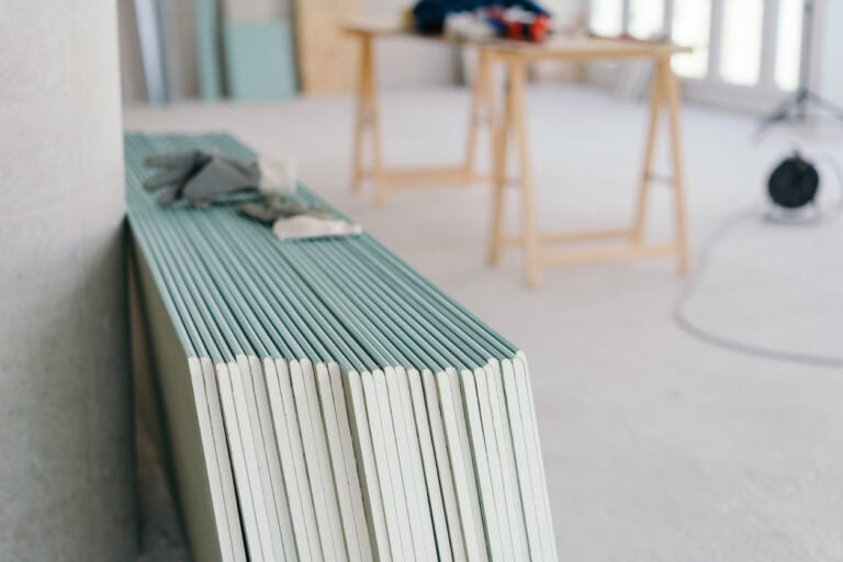 White chip board stacked inside a new build house